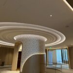 A hotel lobby featuring an elegant circular ceiling, showcasing modern design and inviting ambiance.